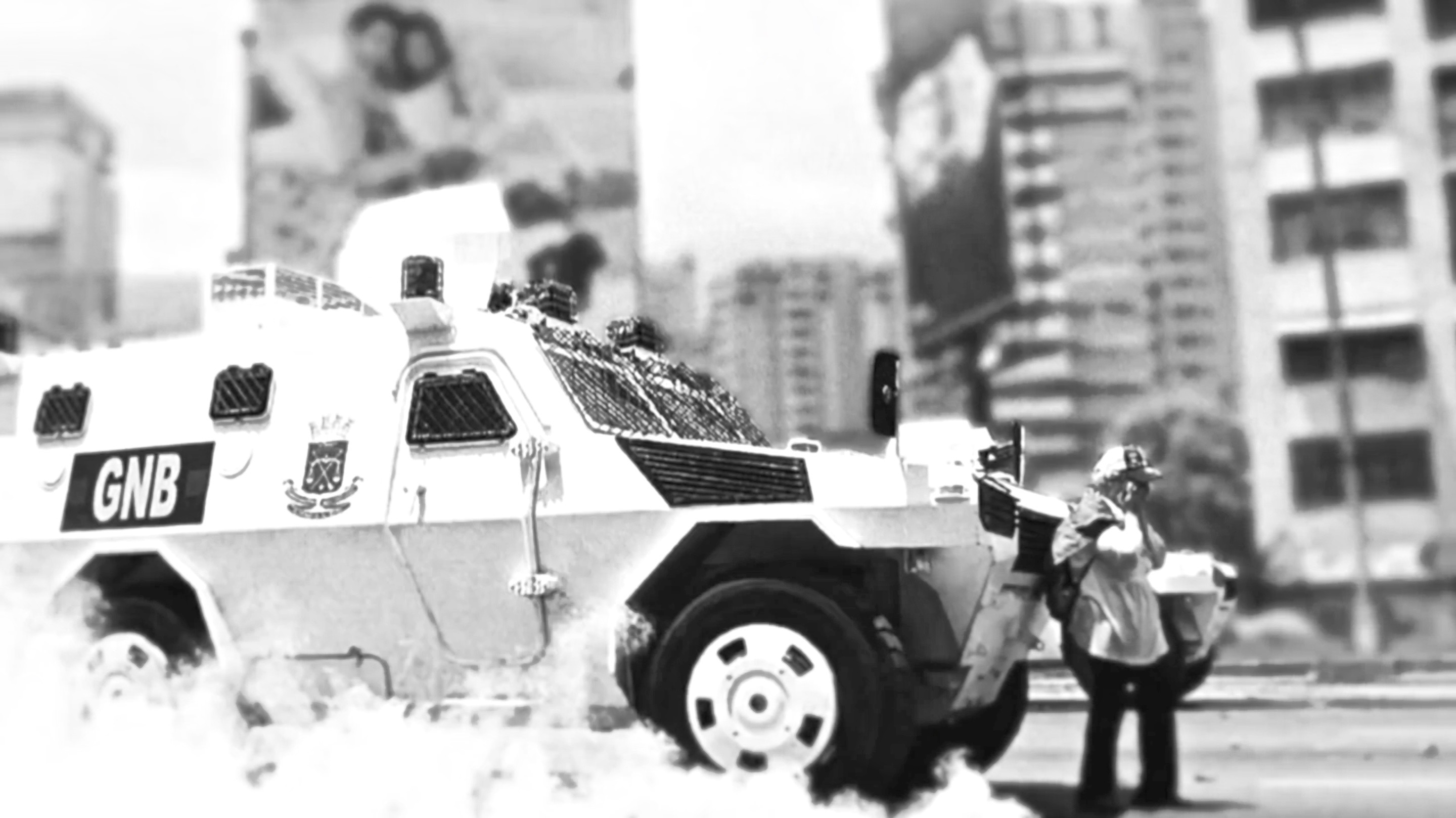 Woman confronting armored vehicle during protests in Caracas in 2017.